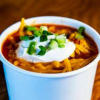 Chili · Beef chili with pinto and kidney beans. Garnished with cheddar cheese, sour cream and green ...