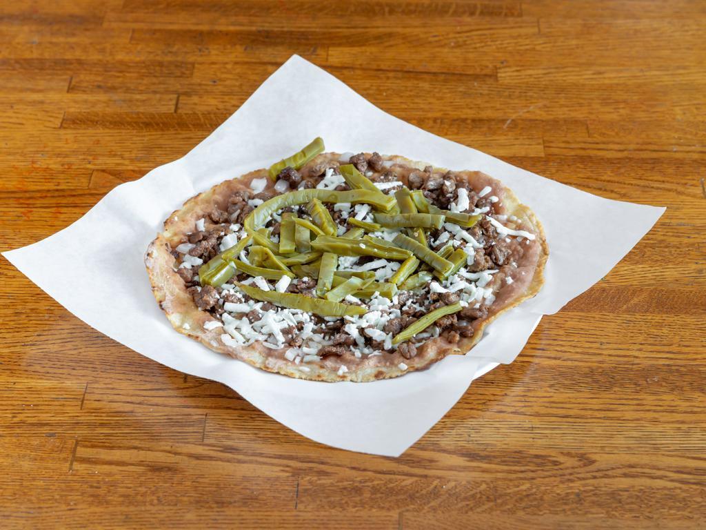 29-A. Huarache · Big corn tortilla, beans, onion, Mexican cheese, cactus leaf and meat.