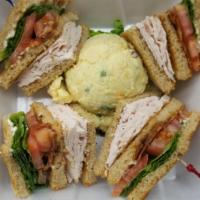 Sliced Turkey Club Sandwich · Crisp bacon, lettuce , tomato and mayonnaise. Served with french fries or potato salad, cole...
