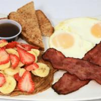 125. Champion Breakfast · 2 Organic eggs, two strips of turkey bacon 97% FF, two protein pancakes, banana, strawberries.