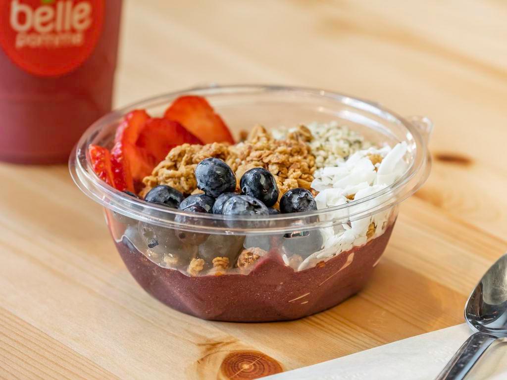 Berry Acai Bowl · Blueberries, acai, banana, spinach, coconut water, dates topped with granola, blueberries, strawberries, hemp seeds, and banana.