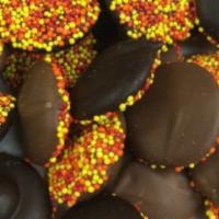 Chocolate Non-Pareils · Rich Belgian chocolate funneled onto colored nonpareils.
