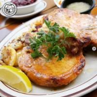 Broiled Pork Chops · Two pork chops season and cooked with herbs and wine