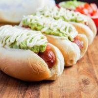 Completo Sandwich · The Chilean hot dog topped with sauerkraut, tomatoes, avocado and mayonnaise. All nested in ...