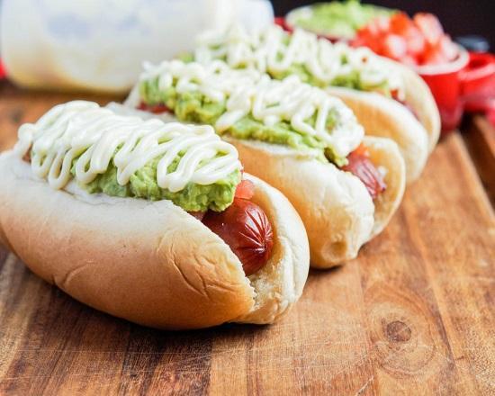 Completo Sandwich · The Chilean hot dog topped with sauerkraut, tomatoes, avocado and mayonnaise. All nested in our own freshly baked bun.