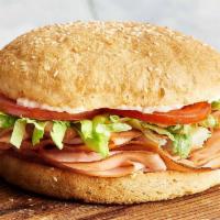 Smoked Turkey Breast · Time to get stuffed. Smoked turkey breast, lettuce, tomato and lite mayonnaise. Served on ou...