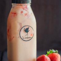 Strawberry Tropic Milk Tea · Sweet and creamy green milk tea mixed with house-made strawberry sauce and boba.