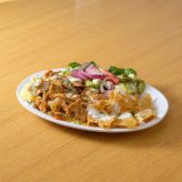 Chicken Shawarma Bowl · Chicken shawarma over rice and white sauce on top and fried pita bread on the side
