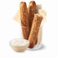 Soft Pretzel Sticks · Soft pretzel sticks, served hot from the oven, covered in butter and salt, served with warm ...