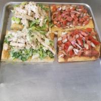 Caprese Pie · On a thin crust garlic square pie with cubed tomato, fresh mozzarella, diced red onion and b...
