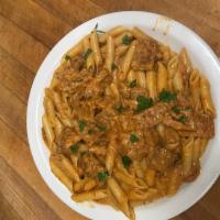 Penne Vodka · Sauteed onions and prosciutto in a pink sauce with a splash of vodka.