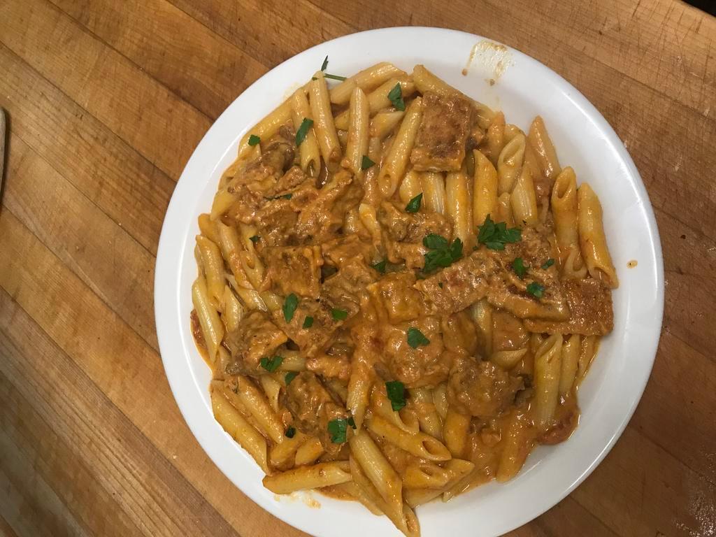 Penne Vodka · Sauteed onions and prosciutto in a pink sauce with a splash of vodka.