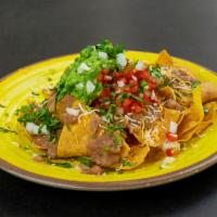 Nachos with Meat · Your choice of meat. Topped with fresh guacamole, black or pinto beans, Jack or cheddar chee...