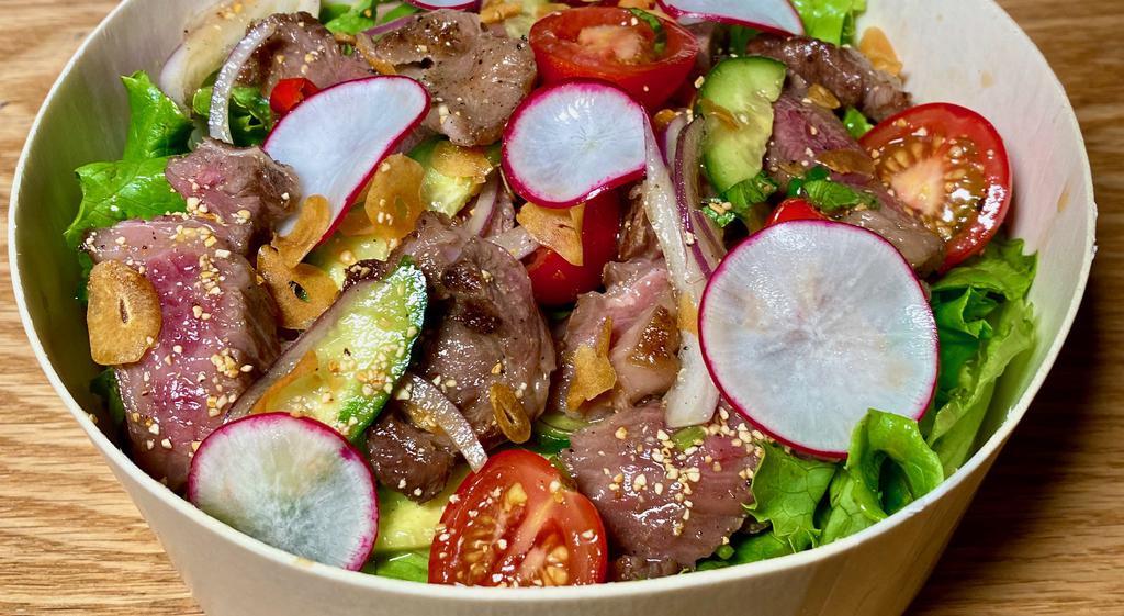 Thai Style Wagyu Salad · 4 Oz of Grilled Japanese A5 Wagyu short rib
 dressed with variety of Greens, vegetables and soy fish sauce 