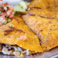 Quesabirria · Flaky, dipped flour tortilla packed with juicy Birria, Chihuahua cheese, and green onions. S...