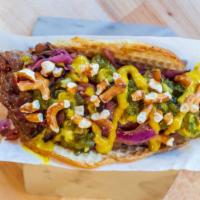 Milwaukee Brat Taco · Diced, beer marinated bratwurst, braised cabbage & onions, and yellow mustard on a pretzel t...