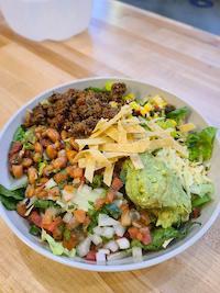 Hiya Taco Salad · Ground beef, pinto beans, lettuce, pico de gallo, chihuahua cheese, corn salsa, guacamole, c...