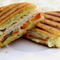 Chicken Cutlet Panini  · Breaded chicken cutlet with American cheese, lettuce, tomato and ranch dressing.