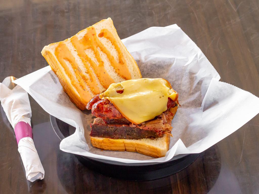 The Hoss Sandwich Combo · Smoked brisket and beef sausage topped with gouda cheese then covered in our special 