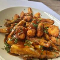 Classic Poutine · Hand-cut french fries with brown gravy and fried cheese curds.
