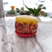 Rainbow Crunch Macarons · Raspberry and honey lemon shell with cranberry cream.
