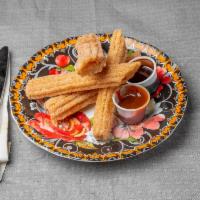 Churros · fried dough pastry with cinnamon covering. Served with chocolate sauce 