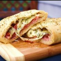 Regular Stromboli · Our secret sauce, ground beef and 100% real cheese wrapped in our fresh dough.