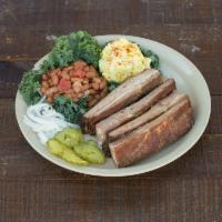 Ribs Plate · Pork spare ribs served with bread, pickles, onions, BBQ sauce, potato salad, pinto beans, or...