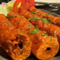 4. Lamb Seekh Kabab · Minced lamb with onions roasted on skewers. Served with basmati rice.