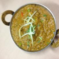 5. Bhartha · Eggplant roasted on a fire and cooked with onions and peas. Served with basmati rice.