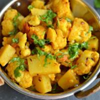 11. Aloo Mutter Gobi · Potatoes, peas and cauliflower cooked with mild spices. Served with basmati rice.