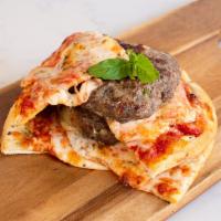 11. Pizza Burger · Margarita pizza, fresh tomatoes, topped with beef burger patty.