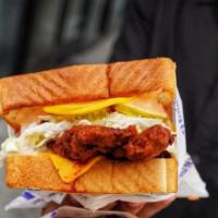 Texas toast Sammie · Fried chicken breast on Texas toast with American cheese, Howdy slaw, sweet pickles and Howd...