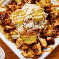 Loaded Chicken Fries · Fried chicken bites, waffle fries, queso cheese, Howdy slaw, sweet pickles and Howdy sauce. 