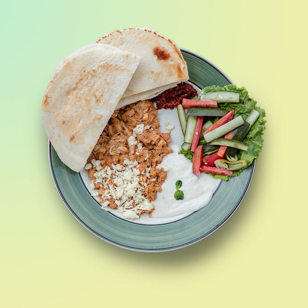 Shredded Chicken Shawarma Dinner · Served with a combination of roasted lamb and beef meats, topped on a bed of rice. Served with our salad and our famous tahini sauce. Served in our home-made pita.