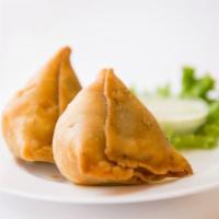 Samosas  · Homemade potato and green peas filling in a flaky turnover flavored with ajwain (carom seeds...