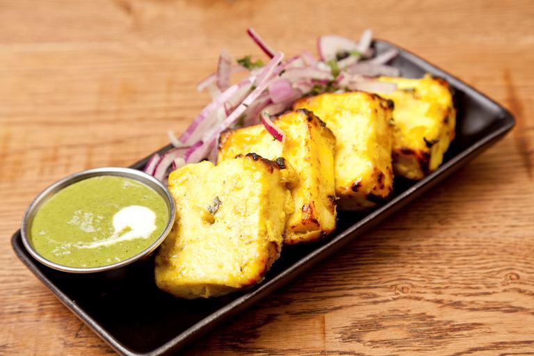 Pudina Paneer Tikka · Indian cottage cheese cubes, arranged on skewers and grilled in tandoor oven with mint.