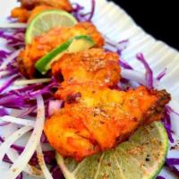 Amritsari Fish · Fillet of fish steaks marinated in traditional spices and griddle fried with a dash of lemon...