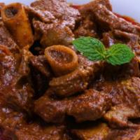 Agra Goat Masala · Juicy and tender goat meat sauteed slowly with special spices. Served with portion of Basmat...