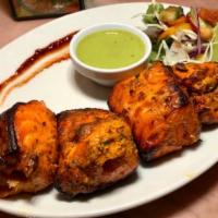 Salmon Tikka  · Marinated salmon cooked in Tandoor and served with a portion of Basmati rice.