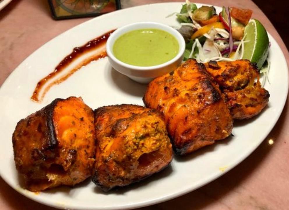 Salmon Tikka  · Marinated salmon cooked in Tandoor and served with a portion of Basmati rice.