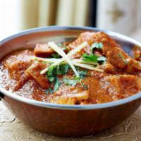 Chicken Xacutie · Chicken cooked with aromatic herbs and spices with coconut and red chilies. Served with port...