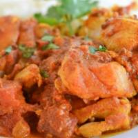 Madras Fish Curry · Fish cooked in a spicy, tangy curry with onions, tomatoes and tamarind. Served with portion ...
