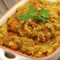 Eggplant Bhartha · Eggplant roasted on fire, stuffed with onions and green peas in medium spices. Served with p...