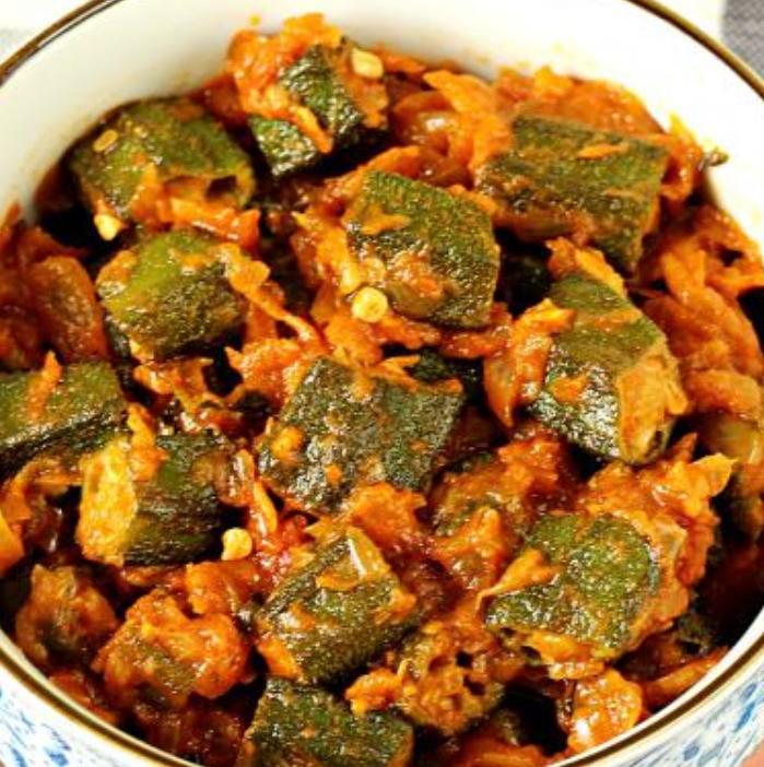 Bhindi Masala · Green okra, stir fried in light spices with onions and capsicums. Served with portion of rice. (Vegan)