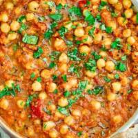 Channa Masala · With chickpeas, a high protein classic recipe with heady flavors. Served with portion of ric...