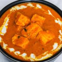 Paneer Makhani · Marinated paneer cooked in flavorful spices and tomato gravy. Served with portion of rice.