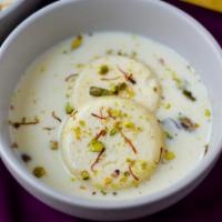 Rasmalai  · Bengali dessert consisting of soft paneer balls immersed in chilled condensed milk flavored ...