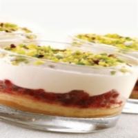Coppa Raspberries & Cream with crushed pistachios · A delicate sponge cake holds a layer of raspberries topped with mascarpone cream and decorat...