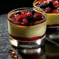 Creme Brulee & Berries · A layer of raspberry sauce topped with a creamy custard and decorated with mixed berries coa...